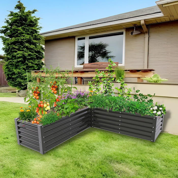 Gray raised garden bed with plants in front of a house #quartz-gray