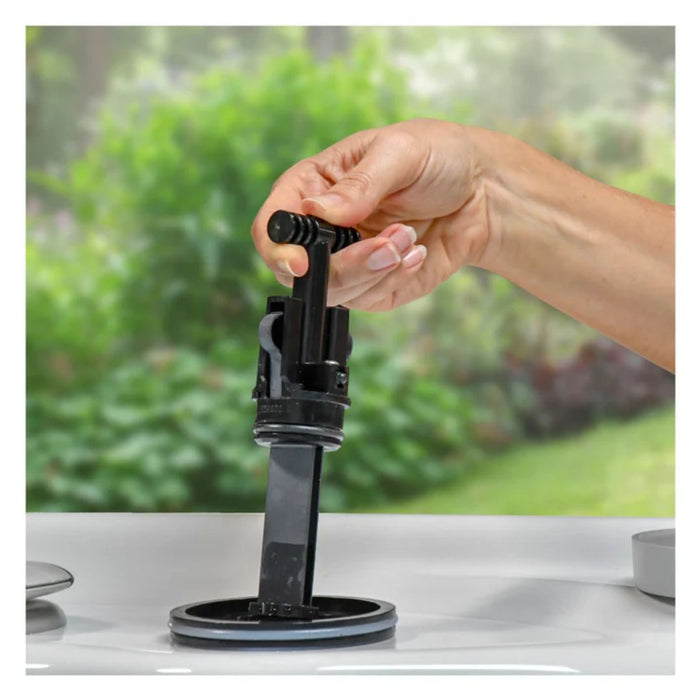A person's hand installing a new FreshWater Salt System replacement cartridge into the top-side port of a hot tub