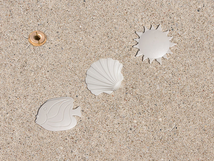 HPI Deck Creations decorative snap-in covers for safety pool cover anchors in fish, sunburst, and seashell styles