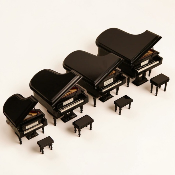 Miniature grand piano models shown in multiple sizes