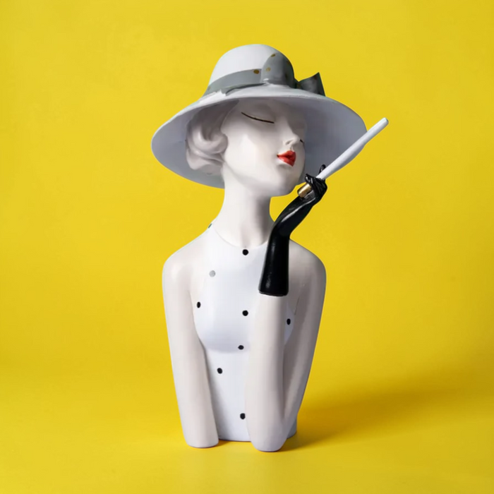 White hat lady sculpture on yellow background