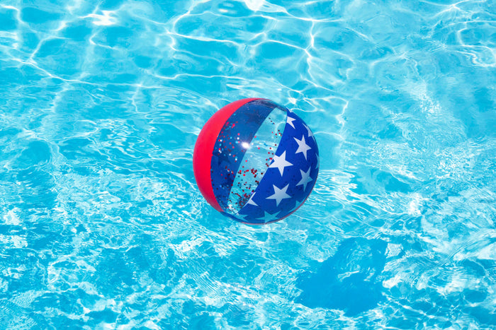 Swimline Americana Glitter 22-inch Beach Ball floating in a swimming pool